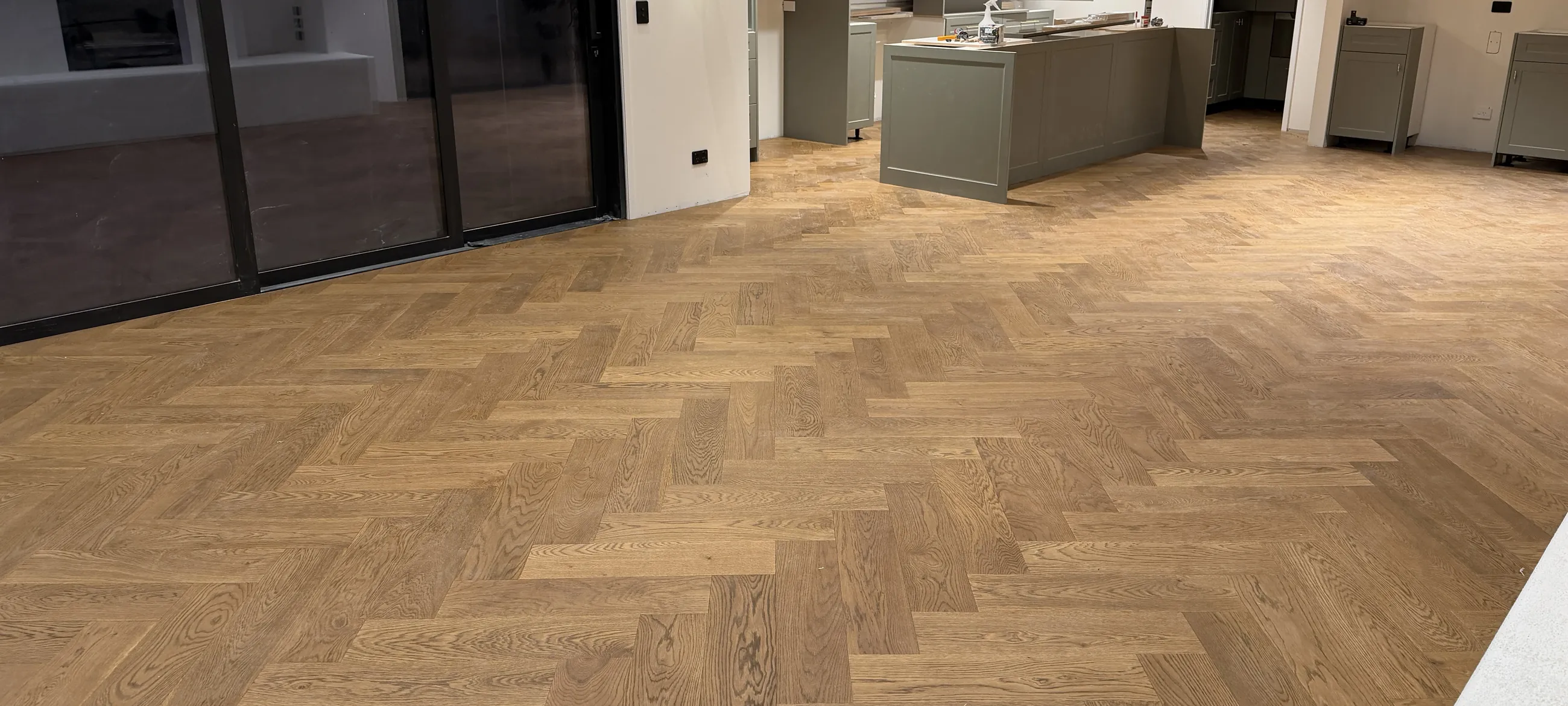 Herringbone oak floor across an open living space
