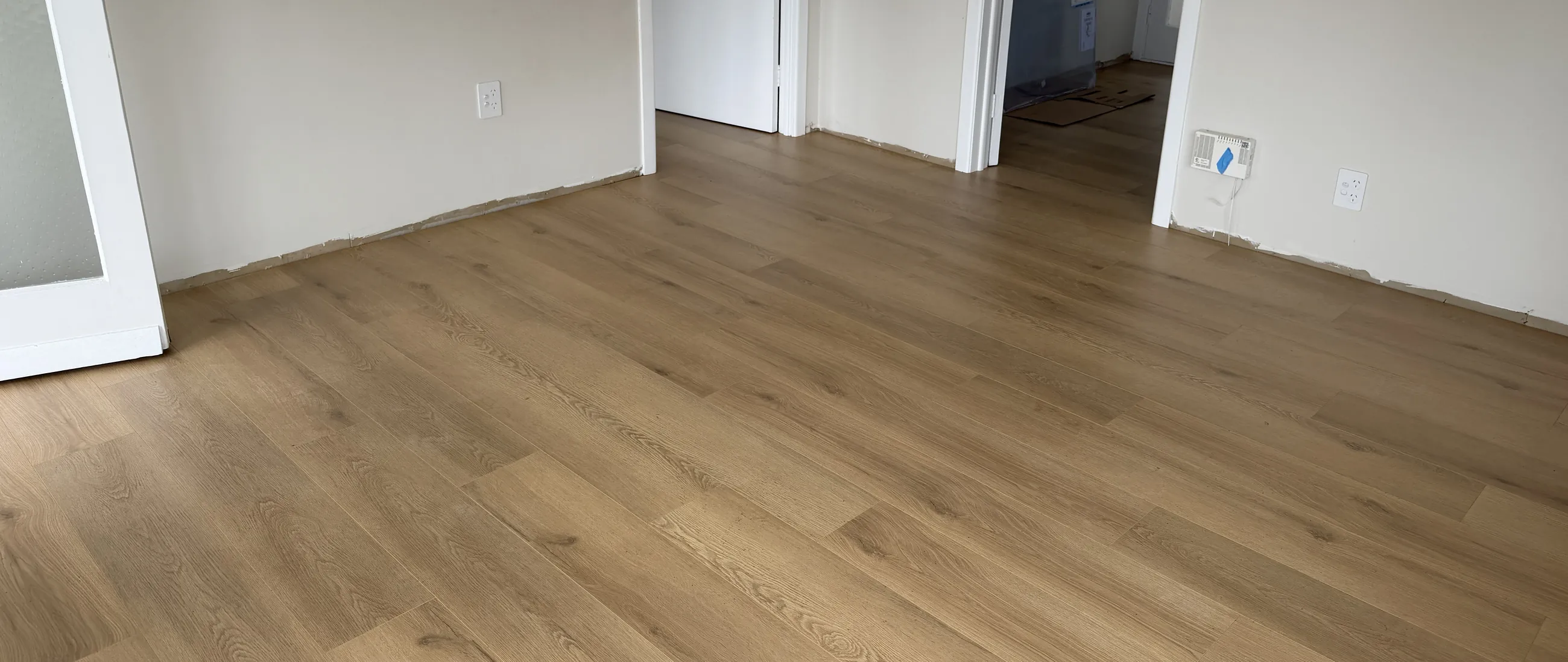 Laminate plank floor through connected rooms