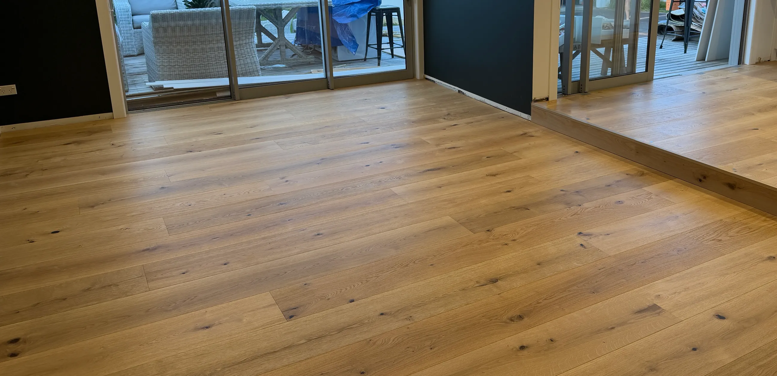 Select-grade oak plank floor with a step-up between rooms