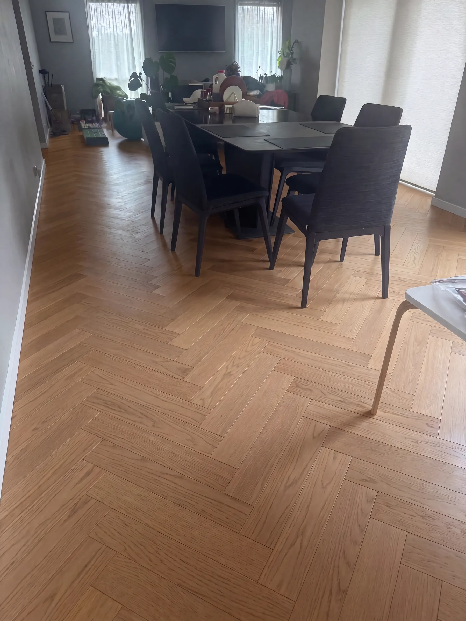 Hamptons herringbone engineered timber under the dining table in a furnished home