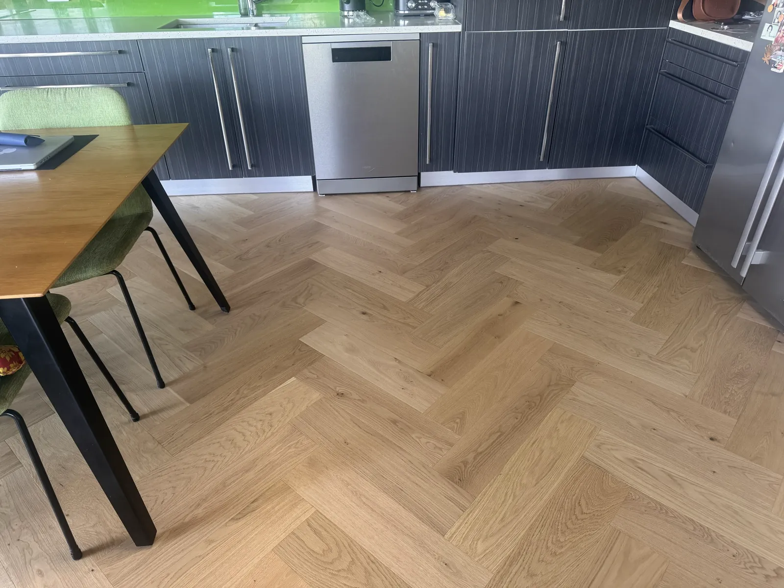 Natural Clear herringbone engineered timber across the kitchen floor at Whangaparaoa Road, Red Beach, furniture back in place