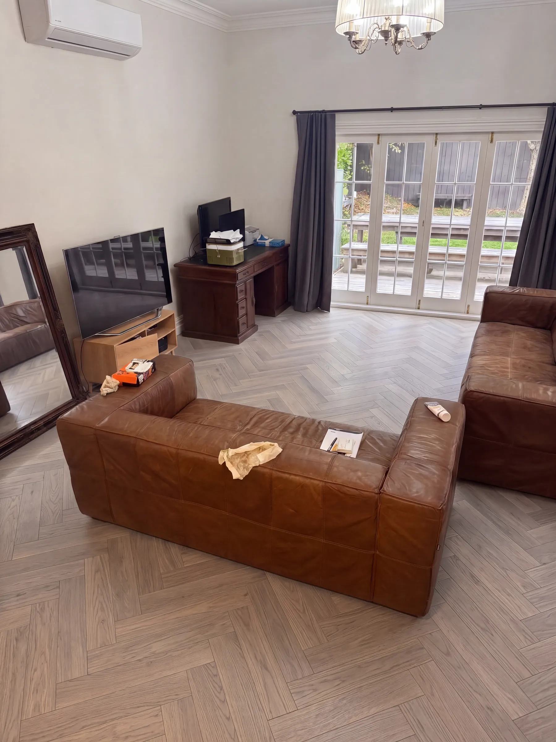 Sterling herringbone engineered timber in a living room with brown leather sofas