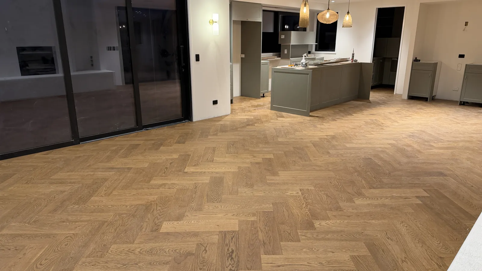 Vintage herringbone engineered timber through the open plan at Ellett Road, Karaka