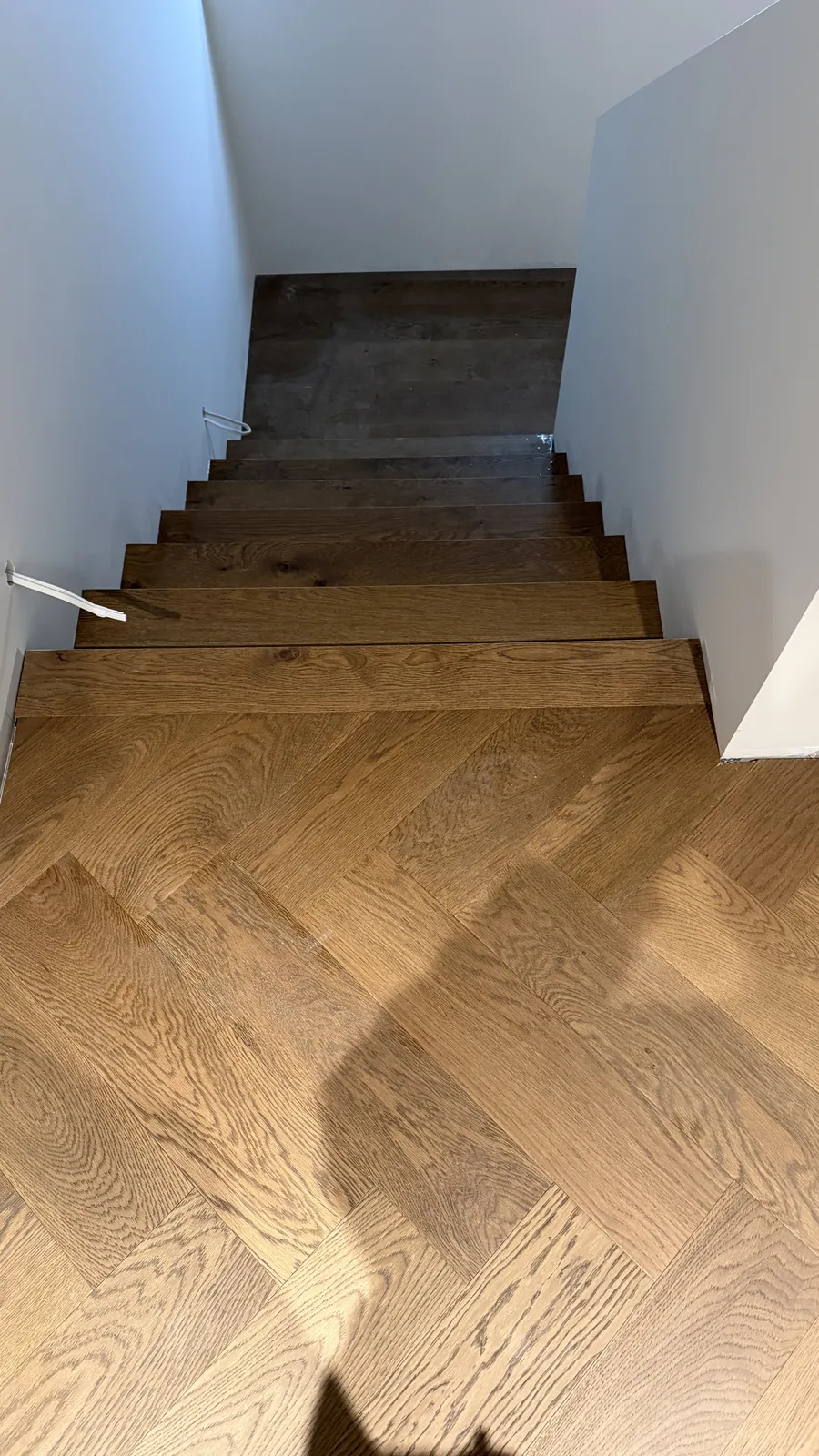Stairs in matching treads descending to Vintage herringbone engineered timber at Ellett Road, Karaka