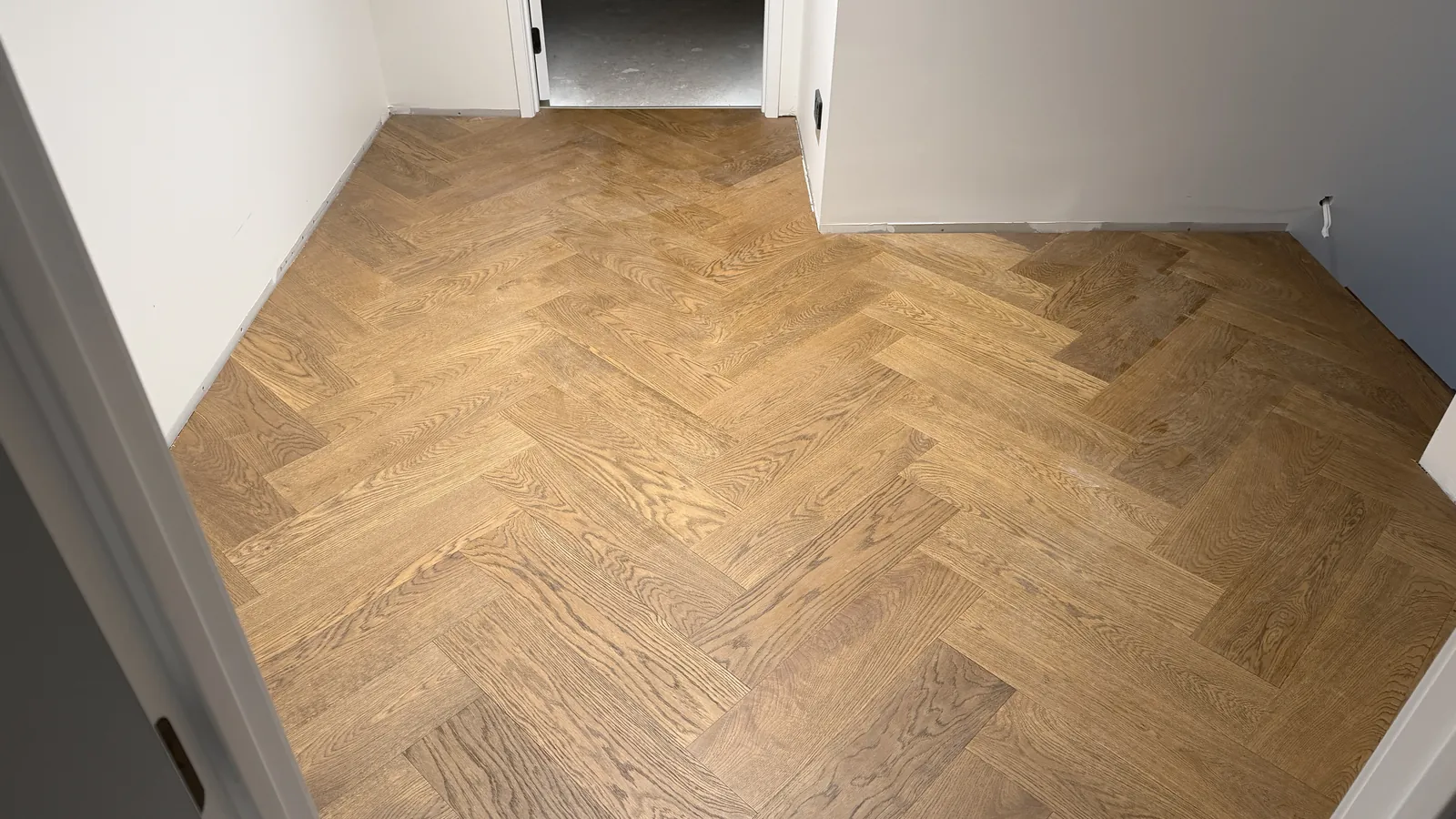 Vintage herringbone engineered timber wall to wall in a bedroom at Ellett Road, Karaka