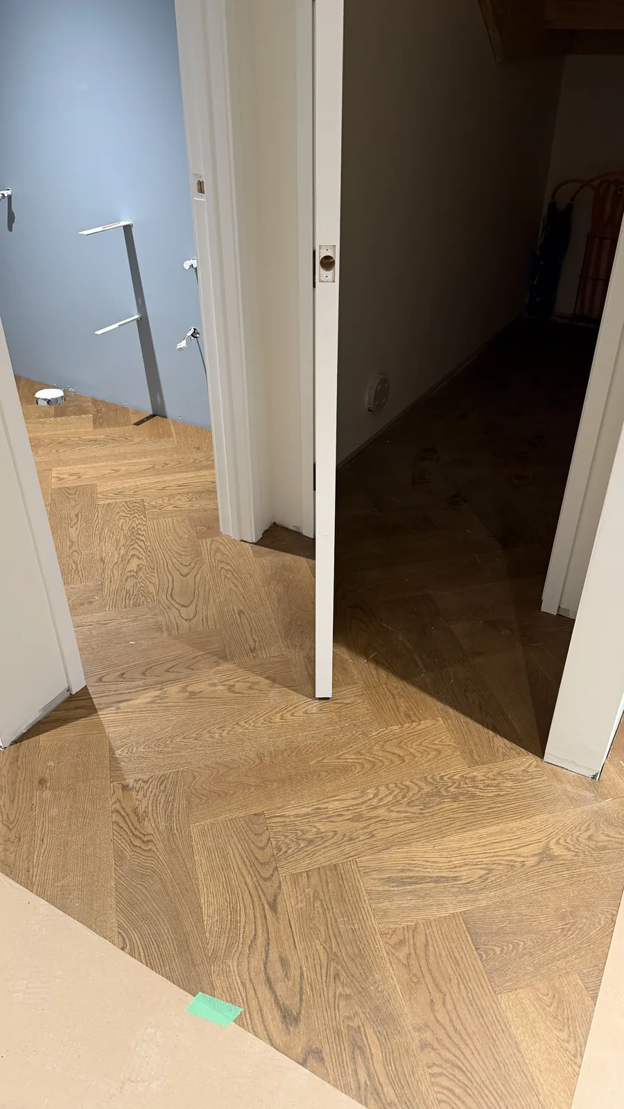 Vintage herringbone engineered timber running through a hallway and doorways at Ellett Road, Karaka