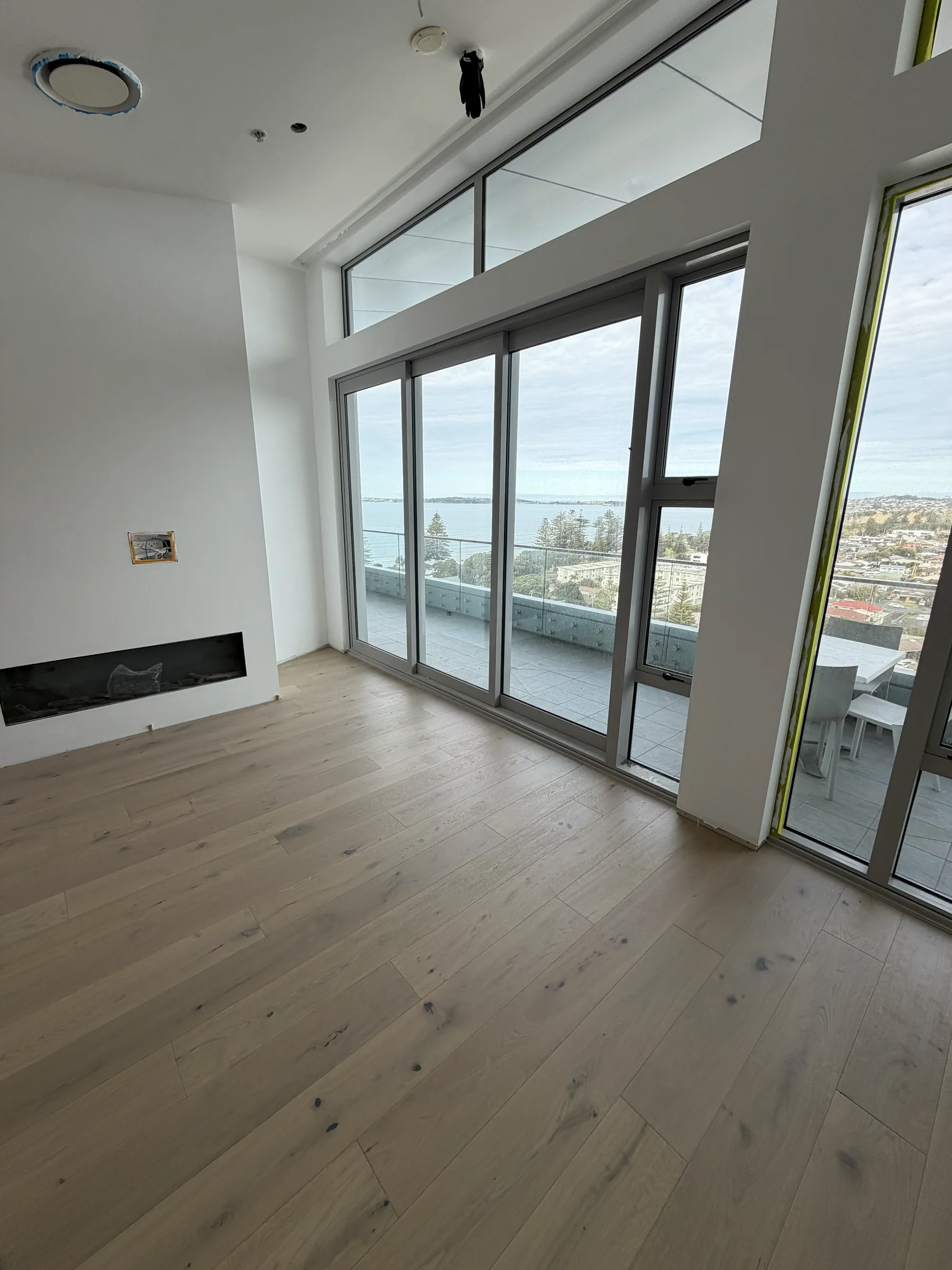 ATS Timber Latte Luxury 190mm flooring meeting floor-to-ceiling glass at The Nautilus, Orewa