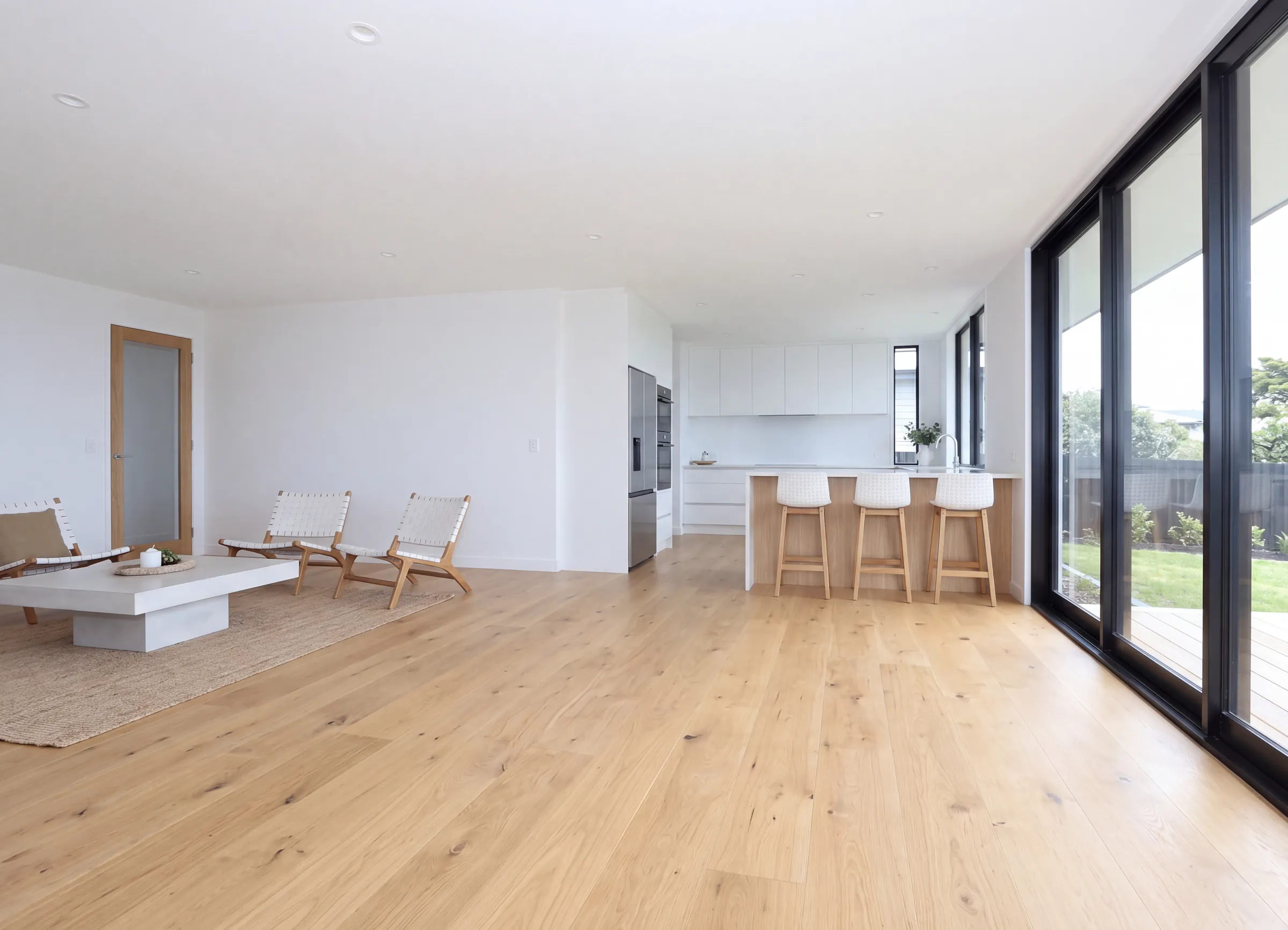 Natural Clear oak plank running from an open living room into the kitchen