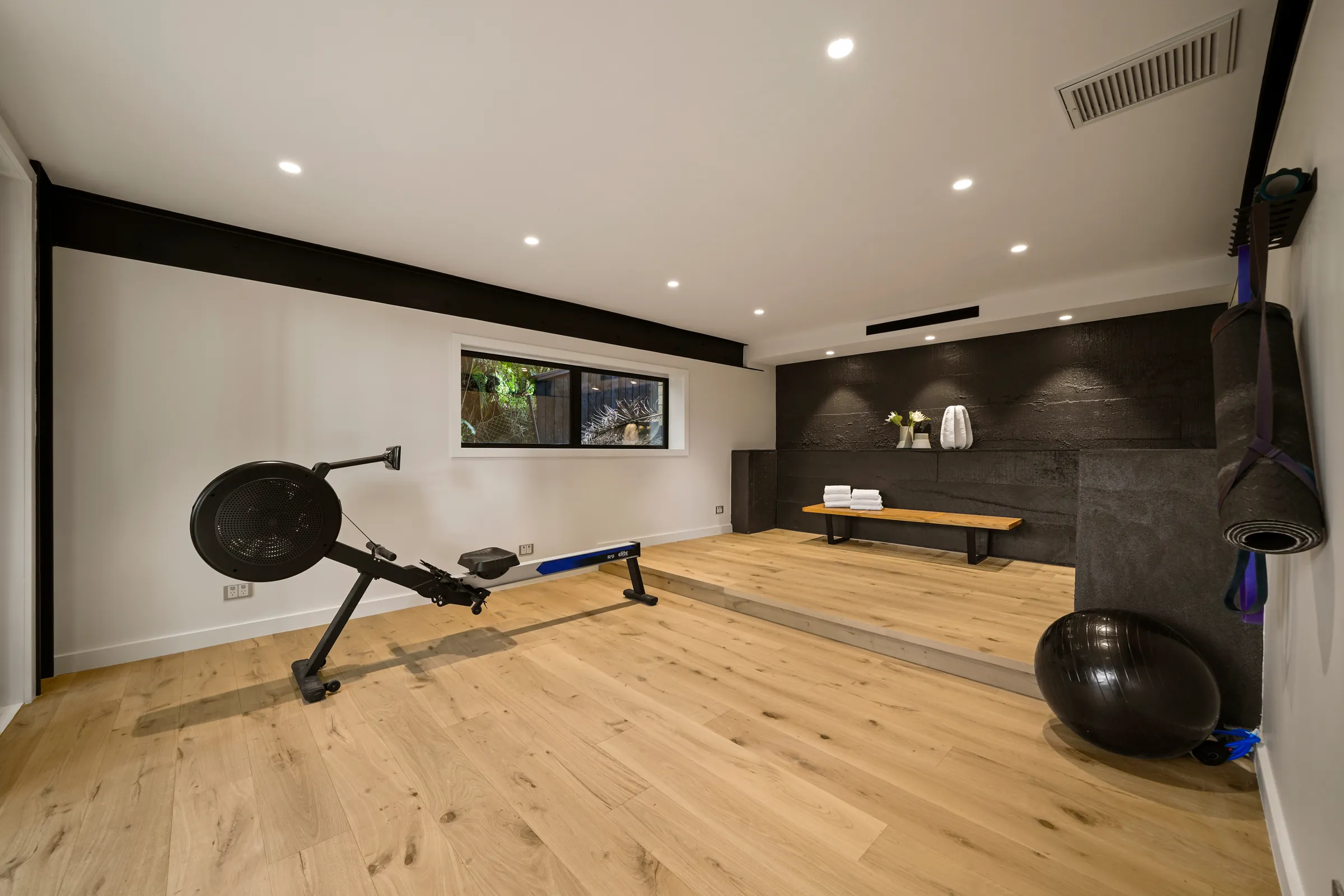 The home gym with a raised platform on Raw 260 wide engineered timber at Seaview Road, Remuera