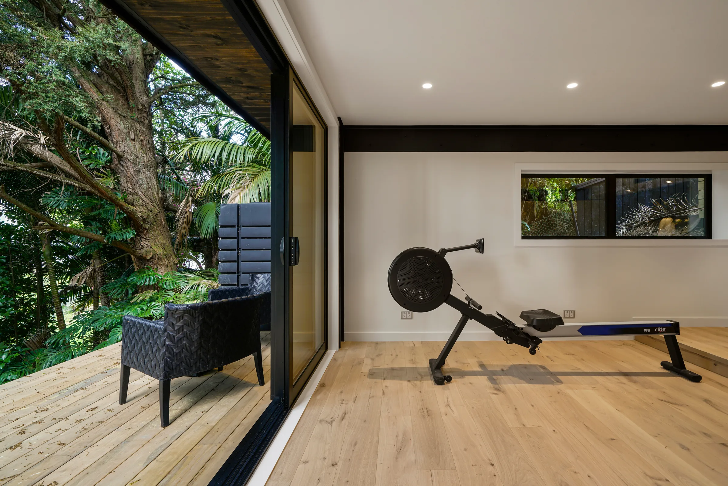 The gym opening to the bush deck over Raw 260 wide engineered timber at Seaview Road, Remuera