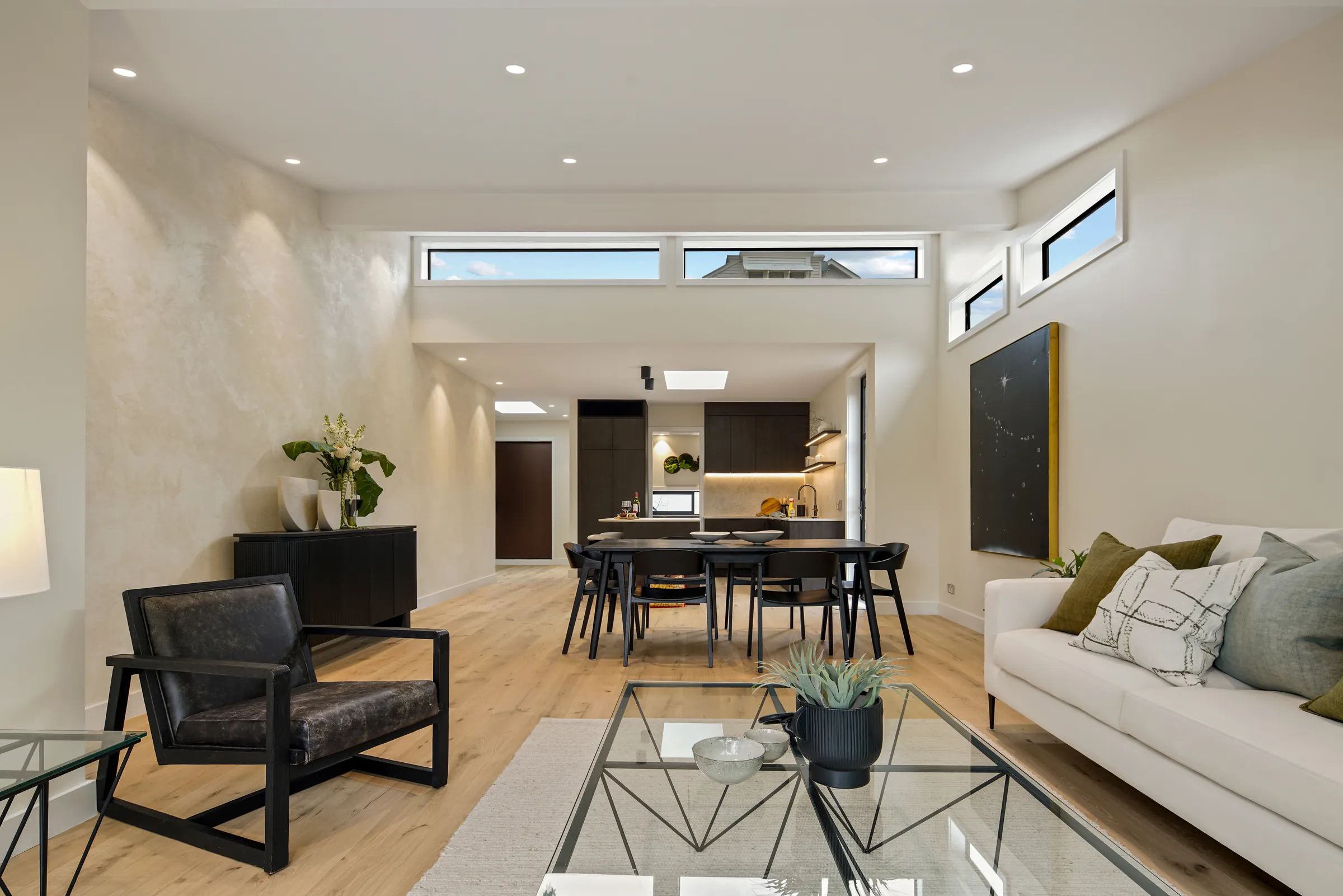 The living room looking back to the kitchen across Raw 260 wide engineered timber at Seaview Road, Remuera