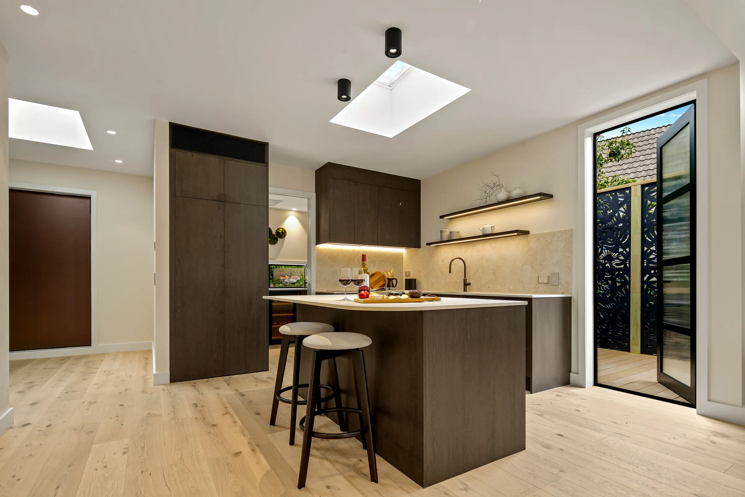 The kitchen and steel-framed door to the courtyard over Raw 260 wide engineered timber at Seaview Road, Remuera