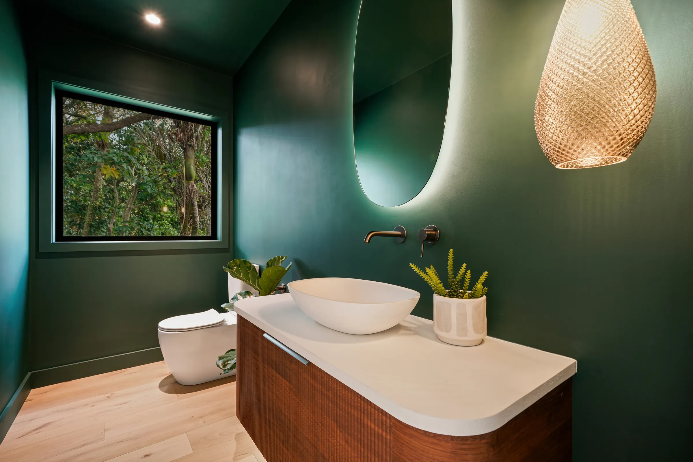 The deep green bathroom with timber vanity on Raw 260 wide engineered timber at Seaview Road, Remuera