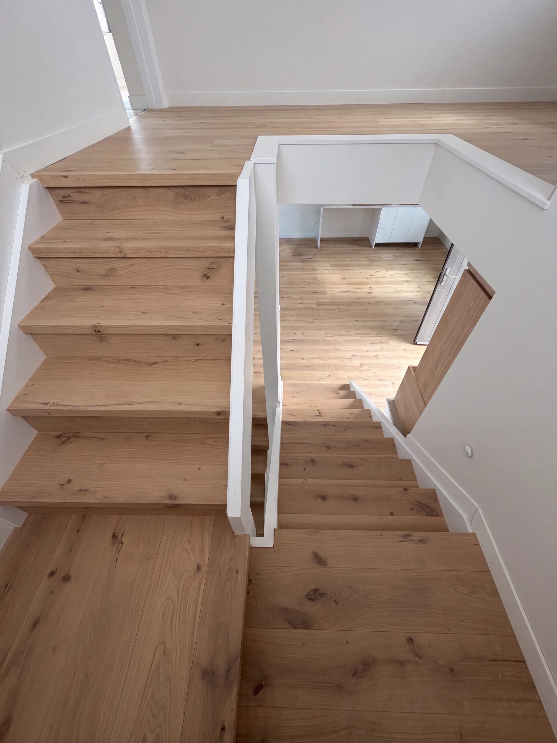 Looking down a Light Oak staircase wrapping its turn at Manapau Street, Meadowbank