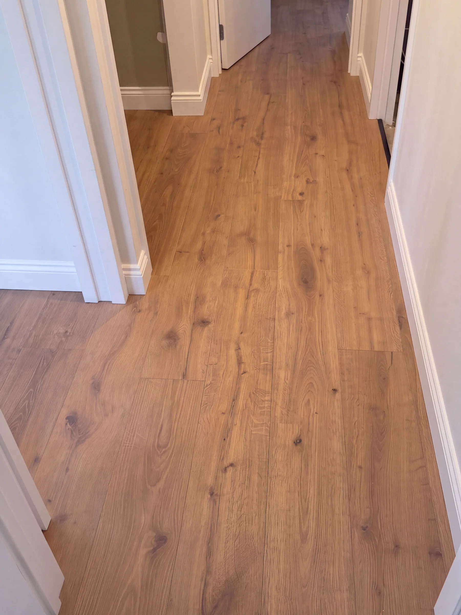 ATS Timber Drift flooring running down a hallway between white doorways at Sentinel Road, Herne Bay