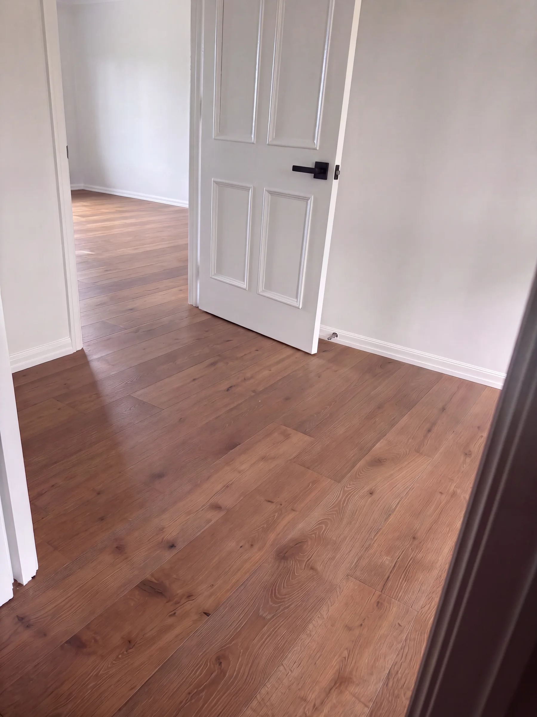 ATS Timber Drift flooring through bedroom doorways at Long Drive, St Heliers