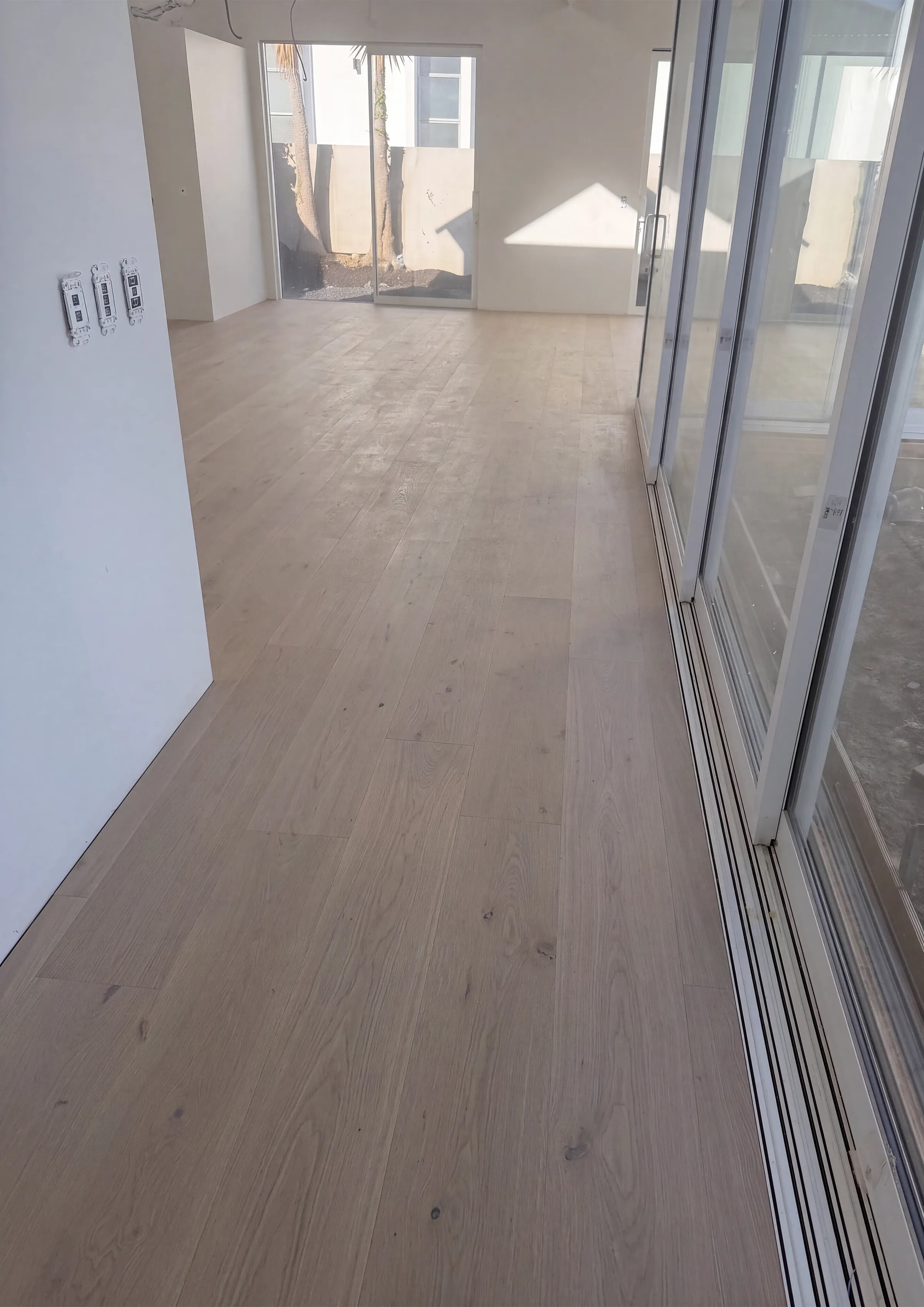 ATS Timber Latte Luxury 260mm flooring running along floor-to-ceiling glass doors at Rose Road, Grey Lynn