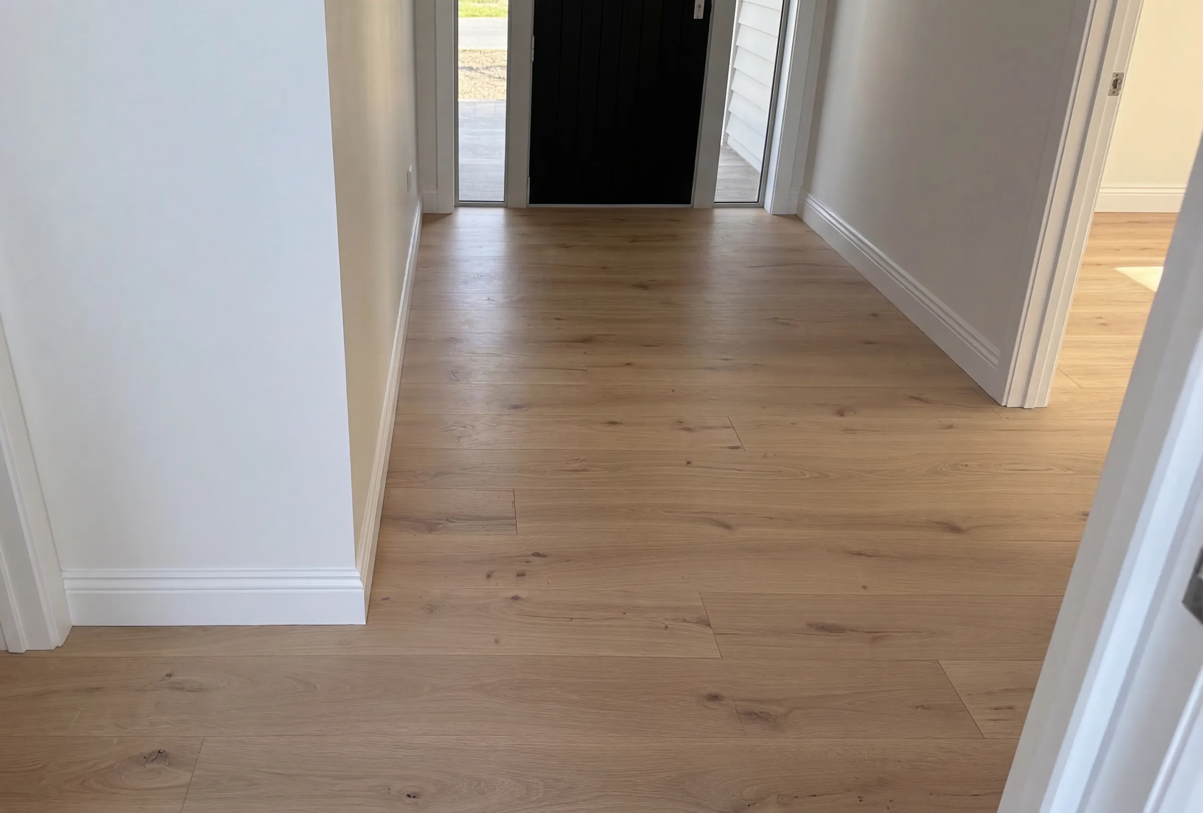 ATS Timber Light Oak flooring running through a new entryway at Spinnaker Drive, Te Atatu Peninsula