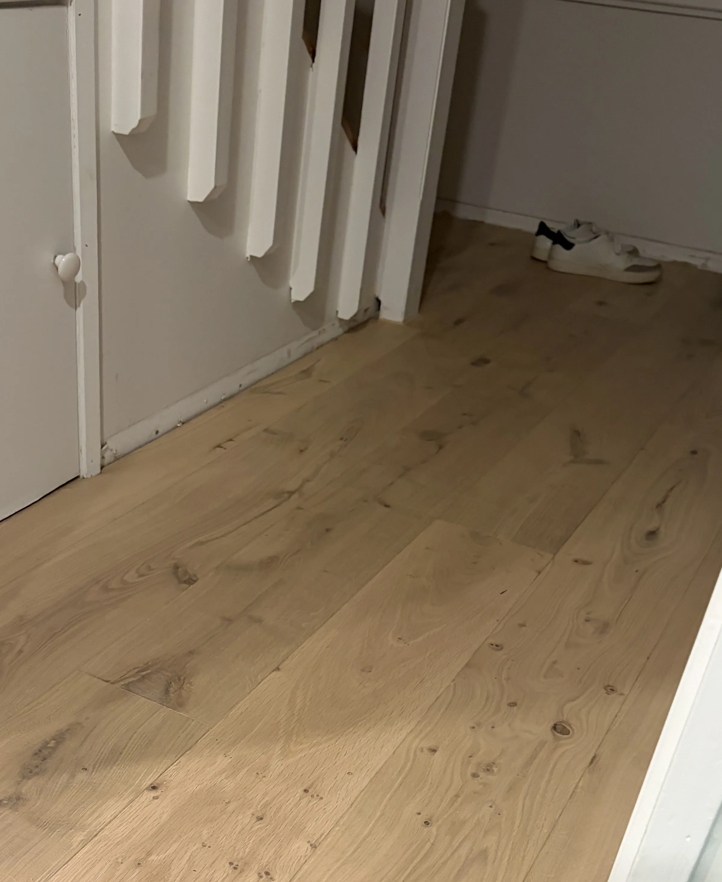 ATS Timber Light Oak flooring wrapping the bottom of a staircase into a hallway at Douglas Street, Ponsonby