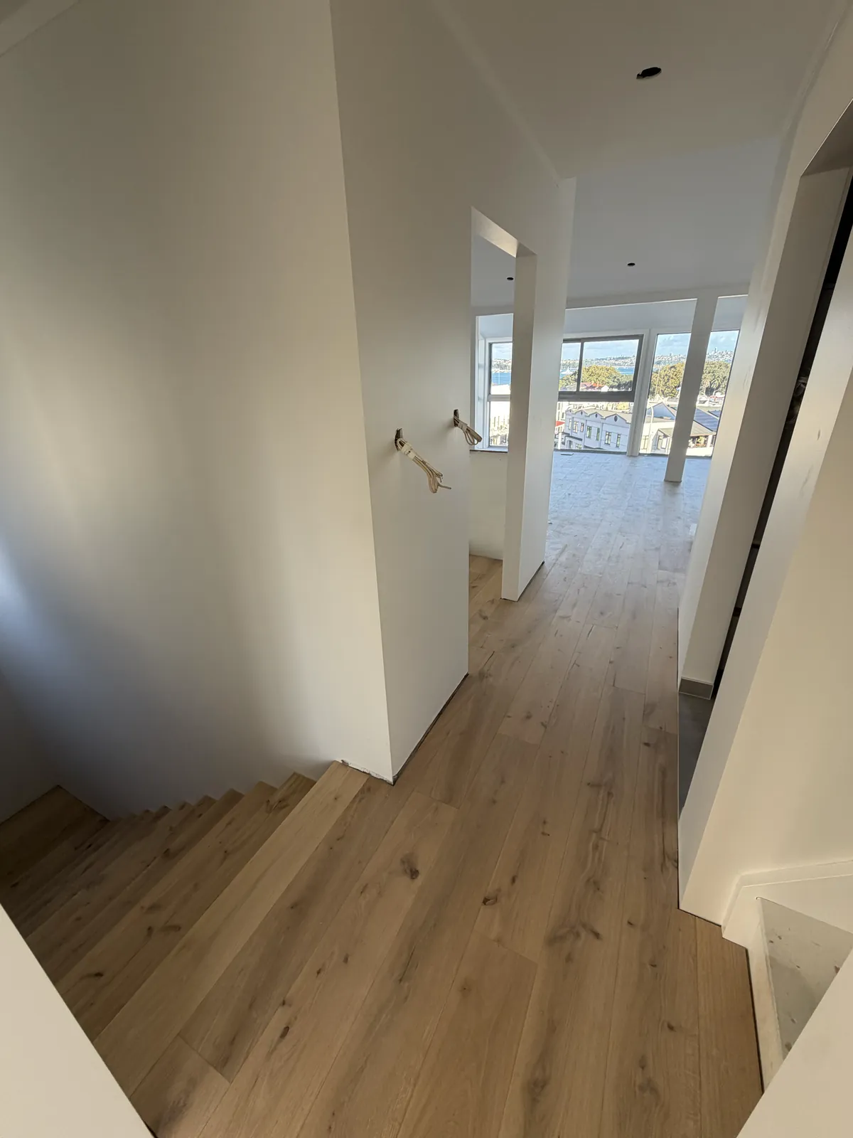 ATS Timber Light Oak from the top of the stairs down a hallway to a room with a water view at Victoria Road, Devonport