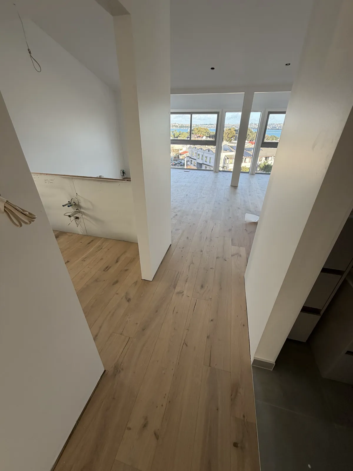 ATS Timber Light Oak running toward the big windows and the water view at Victoria Road, Devonport