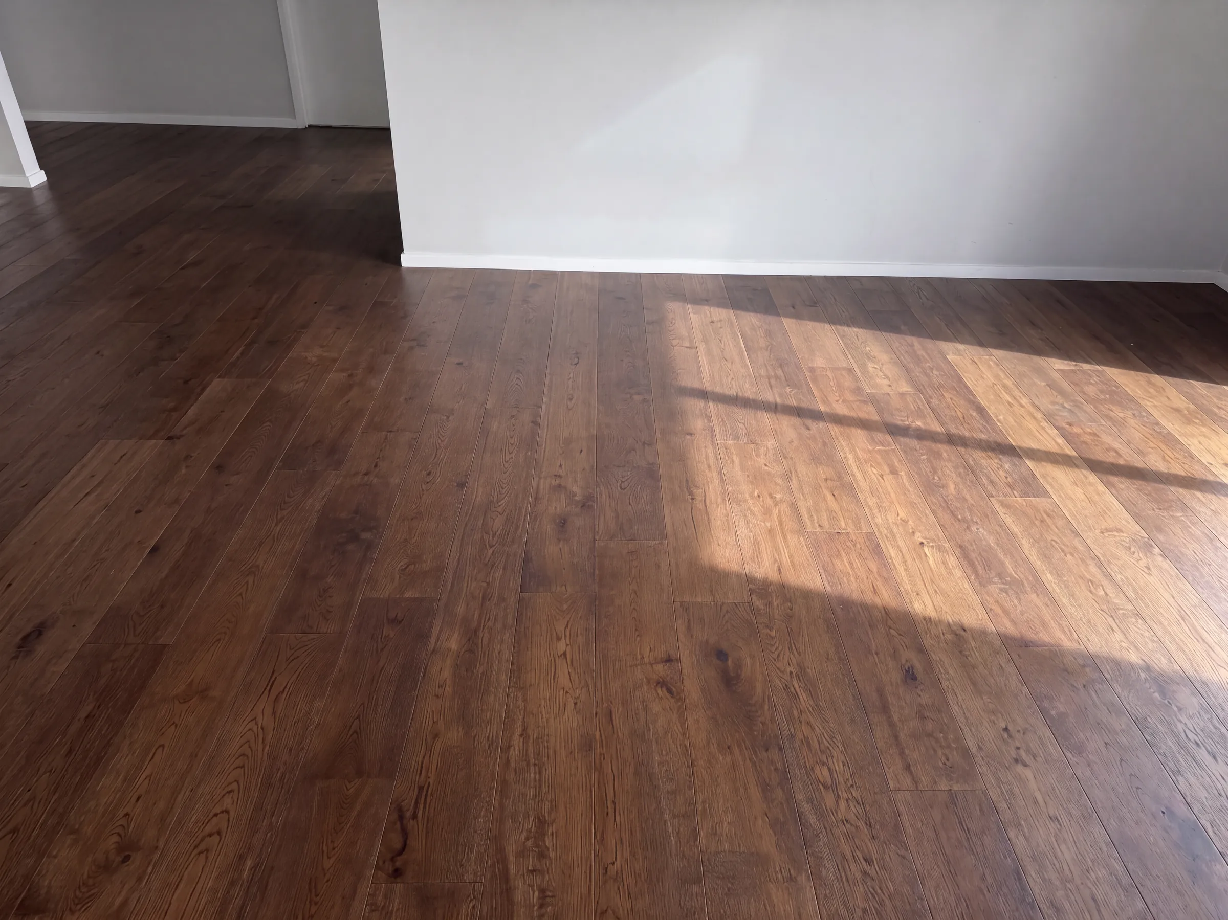 ATS Timber Walnut flooring running dark and rich through a sunlit room at Hiriri Avenue, Remuera