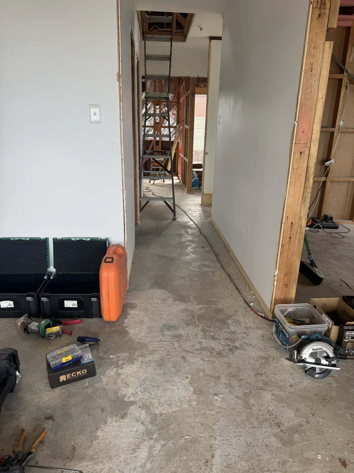 A gutted hallway stripped to the concrete slab at Victoria Road, Devonport